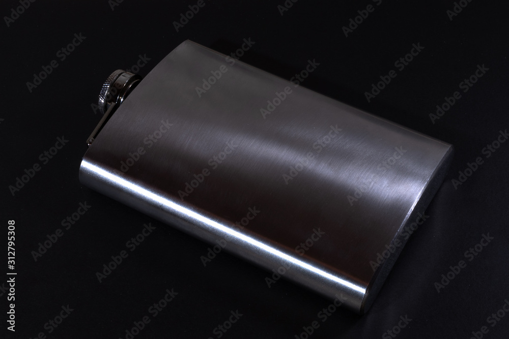 Metall hip flask on black backdrop. Flasks for alcohol. Metall hip flask on black backdrop. Flasks for alcohol.