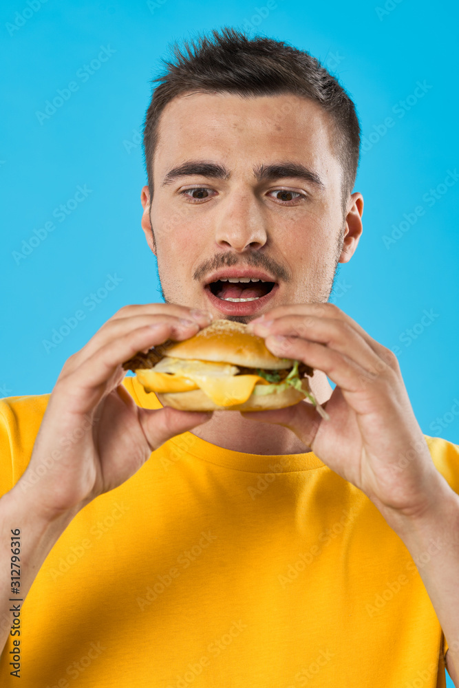 man eating hamburger