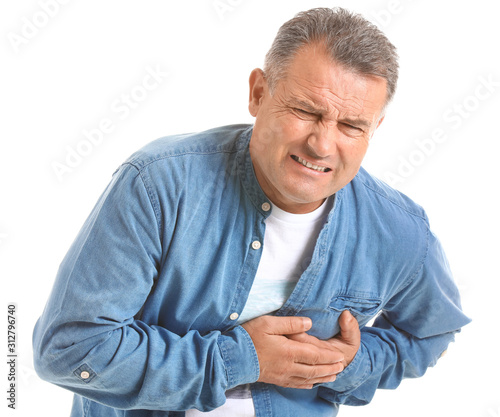 Mature man suffering from heart attack on white background photo