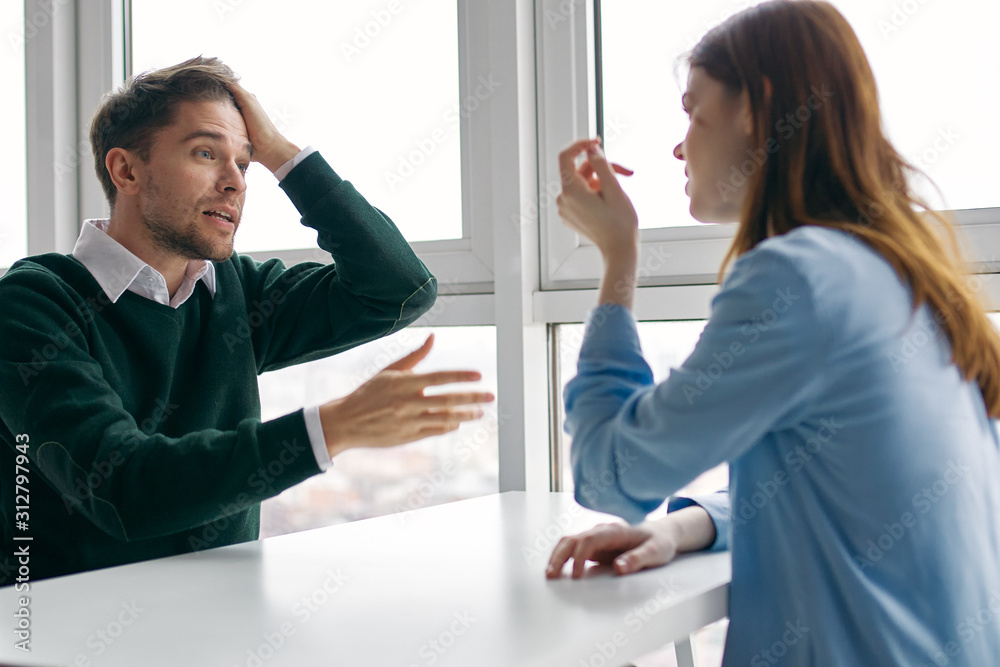 man and woman shaking hands in office