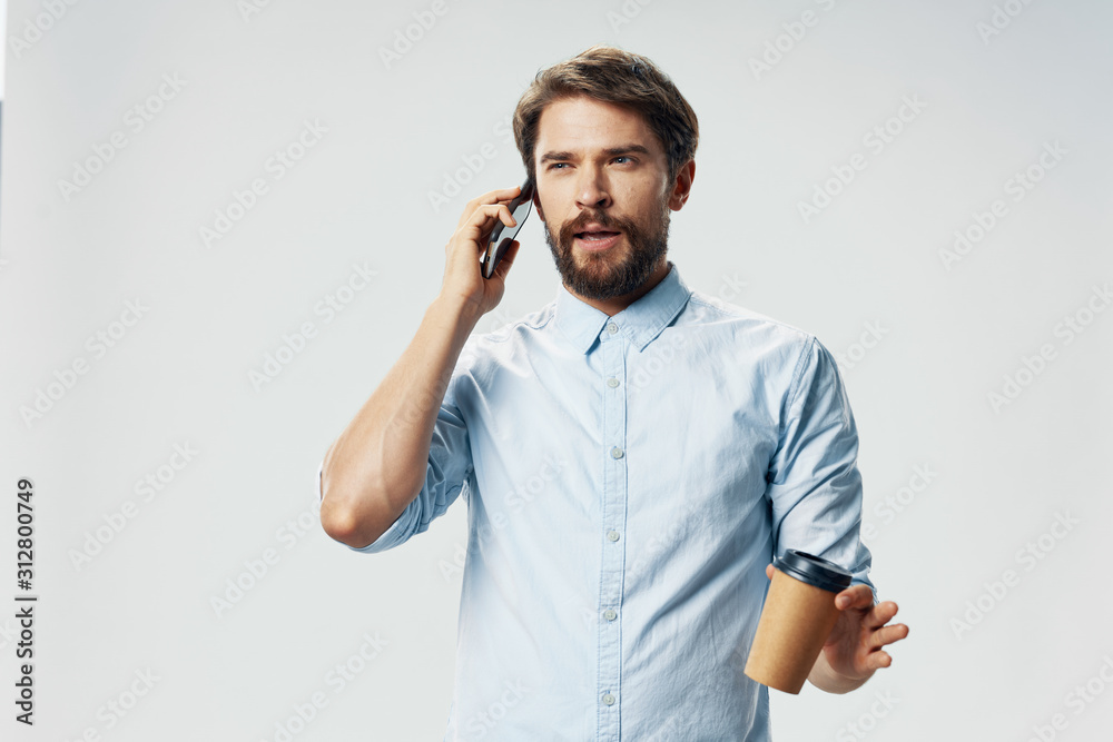 young man talking on the phone isolated on white young man talking on the phone isolated on white