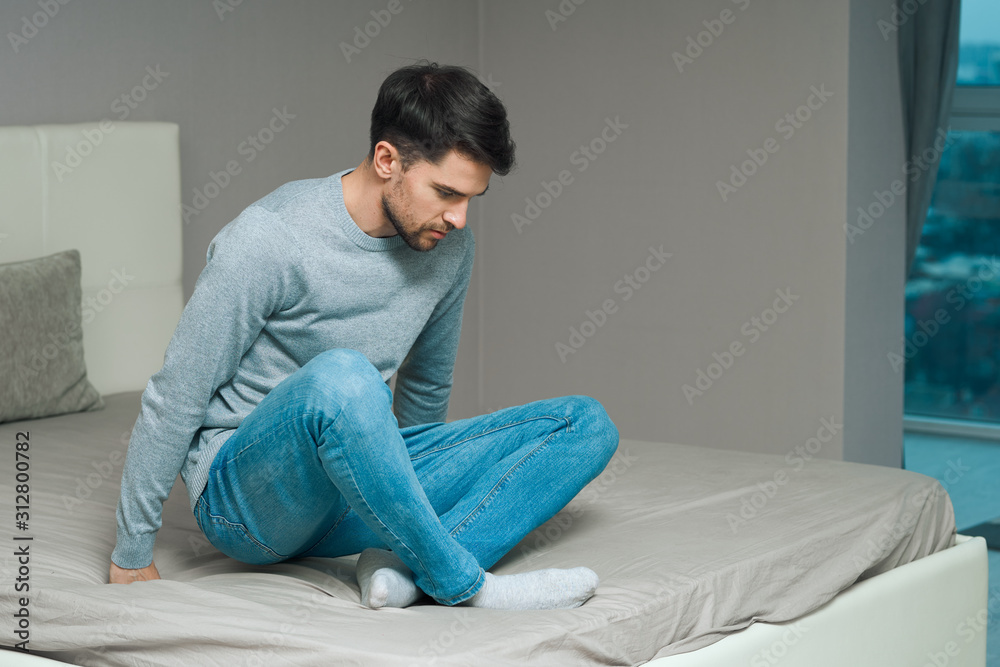 young man sitting on sofa young man sitting on sofa