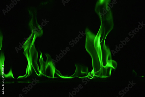 Beautiful fire green flames on a black background.