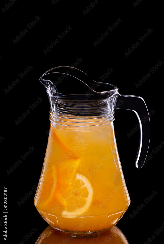 Pitcher with orange syrup and orange slices Pitcher with orange syrup and orange slices