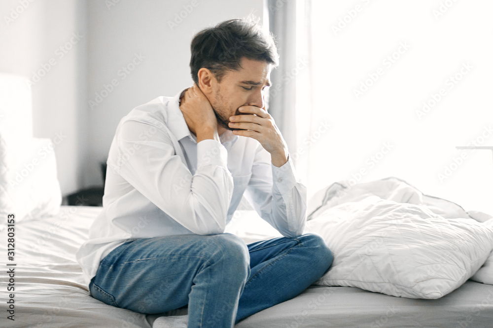 young man sitting on sofa at home young man sitting on sofa at home