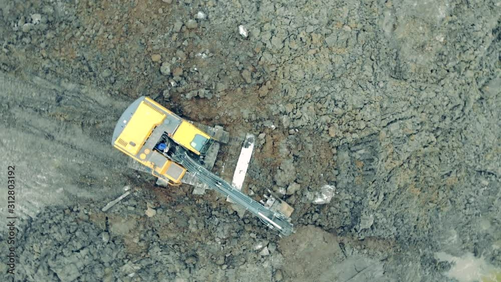 Industrial excavator carries stones in a bucket. Industrial excavator carries stones in a bucket.