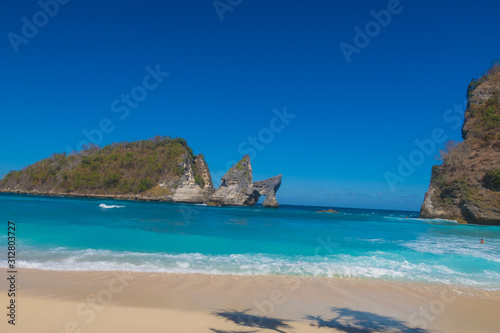 Atuh Beach With Famouse Rock Island Outcrop and Natural Arch Carved By The Bright Turquoise Ocean on Nusa Penida  Bali  Indonesia