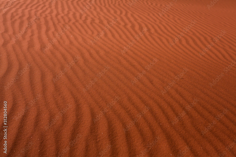 Wadi Rum Desert in Jordan. On the Sunset. Panorama of beautiful sand pattern on the dune. Desert landscape in Jordan. Wadi Rum Desert in Jordan. On the Sunset. Panorama of beautiful sand pattern on the dune. Desert landscape in Jordan.