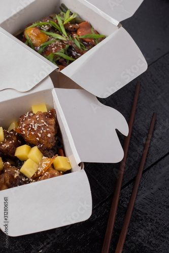 fried chicken set in a box, wok noodles and chopstocks. Top view photo