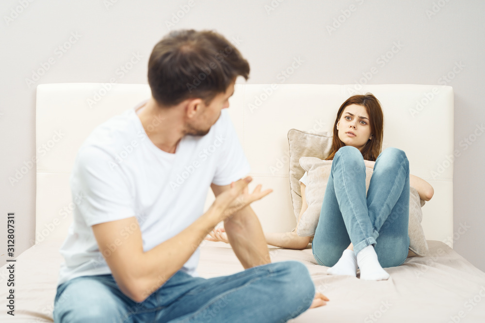 couple sitting on sofa and watching tv