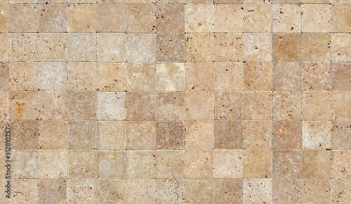Seamless wall background with Yellow natural sandstone tiles stitched together with clay
