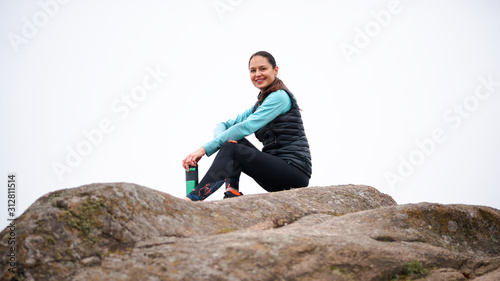 Beautiful Smiling Woman Resting after Running Outdoor. Workout at Autumn Evening. Sport and Healthy Active Lifesyle.