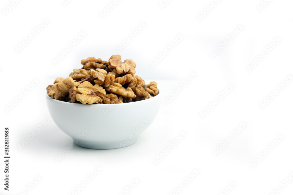 a bowl of peeled walnut isolated on white background a bowl of peeled walnut isolated on white background