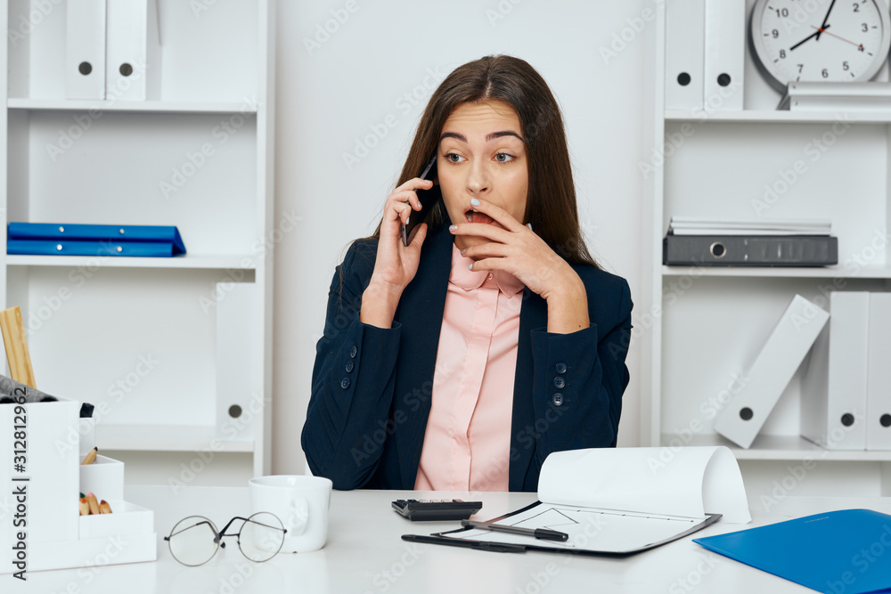 businesswoman talking on phone in office businesswoman talking on phone in office