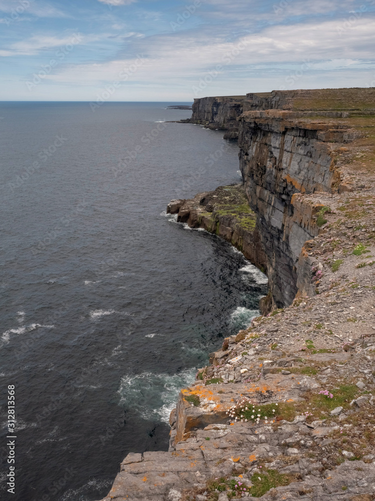 Cliffs of Inishmore, Aran Islands, Ireland, Atlantic ocean, blue cloudy sky. Nobody.