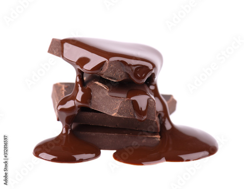 Chocolate pieces stack and chocolate syrup isolated on white background. Close up.