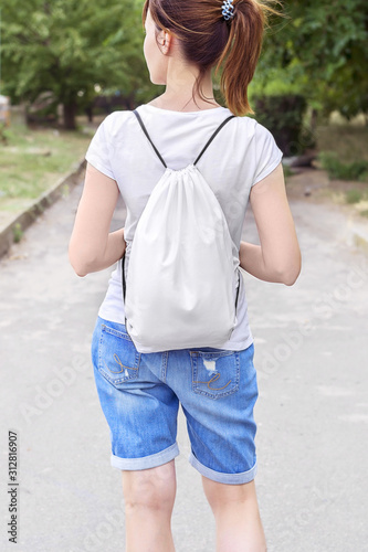 Woman with drawstring bag on the shoulder.