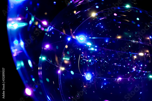 Colored lights in the form of a sphere on a dark background. Abstract dark background. Space emulation