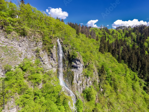 great waterfall and forest view from funicular transport in Borjomi city of Georgia near cable car. Borjomula river flows along green, narrow Borjomi gorge part of Borjomi-Kharagauli Nature Reserve  photo