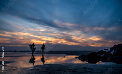 Photography Silhouette of Surfers on the beach at sunset
