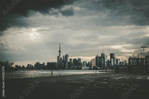 Photography A high-contrast view of the Toronto skyline with a dramatic sky covered in cloud