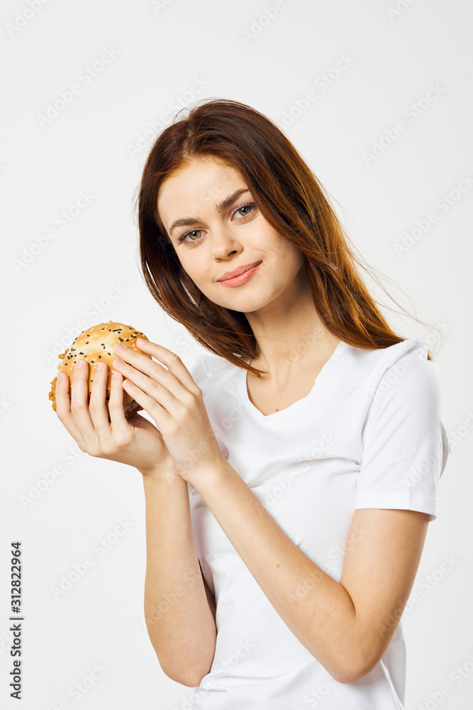 woman with hamburger and french fries isolated on white woman with hamburger and french fries isolated on white