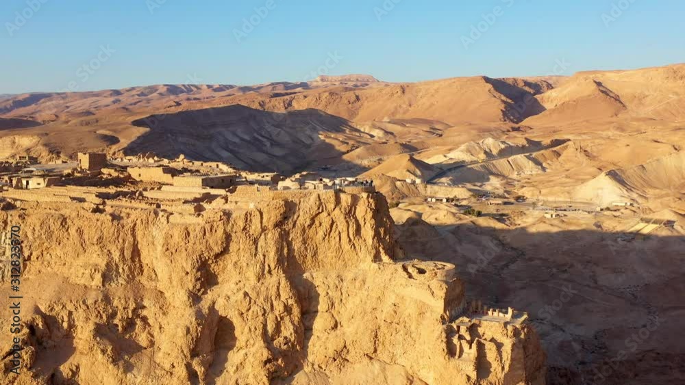 Masada National Park at sunrise, Wide shot Drone View Masada - Aerial footage of the ancient fortification in the Southern District of Israel Masada National Park at sunrise, Wide shot Drone View Masada - Aerial footage of the ancient fortification in the Southern District of Israel