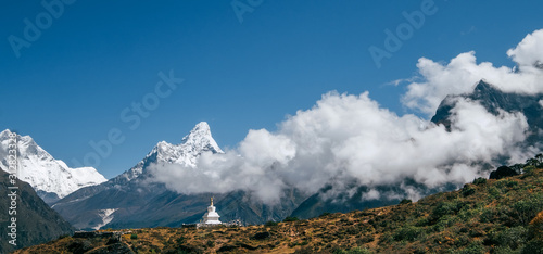 Ama Dablam 6814m main and 5563 m lower . peaks mountain with buddhist stupa on oreground. Everest Base Camp trek route, Khumbu valley, Nepal. photo