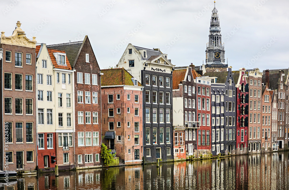 The old houses in amsterdam in a row along a canal. 