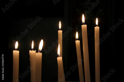 Burning candles isolated on a black background 