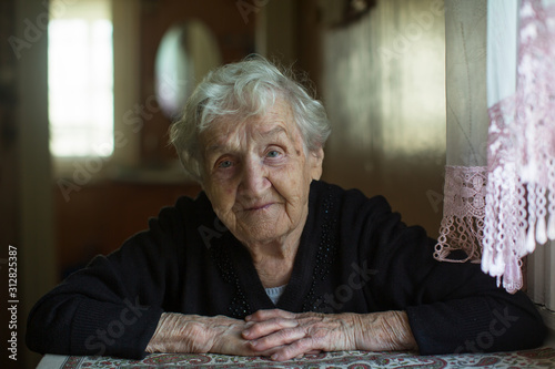 Home portrait of an elderly gray-haired granny woman. photo