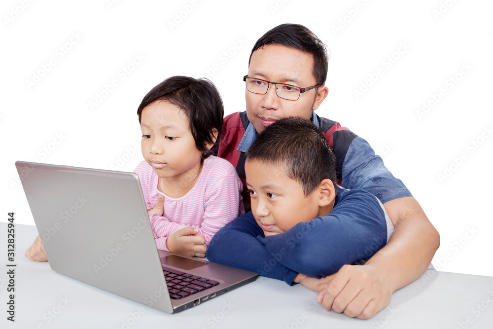 Children observing their father teaching them Children observing their father teaching them