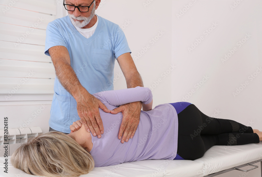 Chiropractic treatment, Back pain relief. Scoliosis Posture Correction. Physiotherapy for female patient Chiropractic treatment, Back pain relief. Scoliosis Posture Correction. Physiotherapy for female patient
