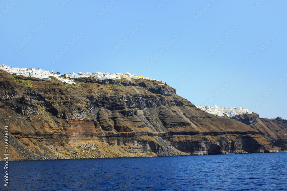 The coast of the Greek island of Santorini with the cliff towns of Oia and Thira The coast of the Greek island of Santorini with the cliff towns of Oia and Thira