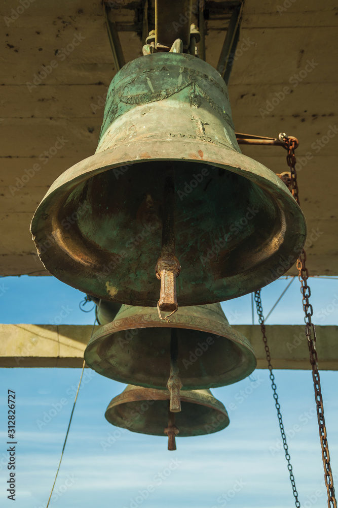 Bronze bells with chain in a country church