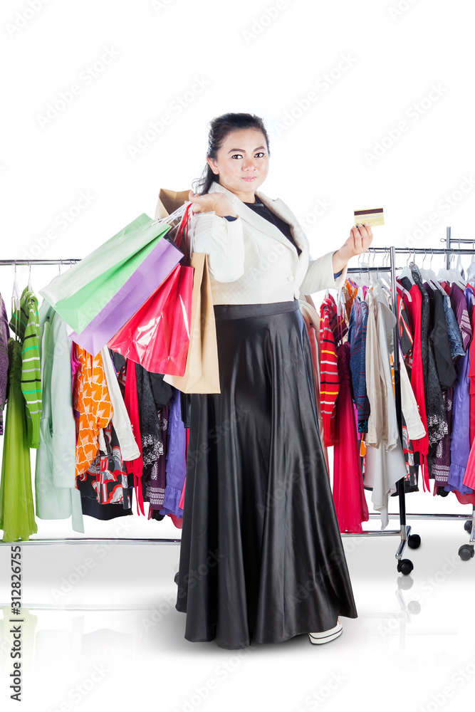 Fat woman holding a credit card and shopping bags
