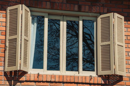 Glazed window with shutters in a country house