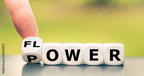Hand turns a dice and changes the word "power" to "flower".