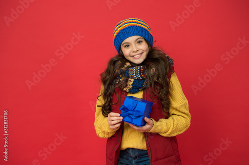 After shopping. girl with new year present box. happy winter holidays. little girl knitted hat and scarf. merry christmas. xmas party mood. winter shopping sales. childhood happiness. nice purchase