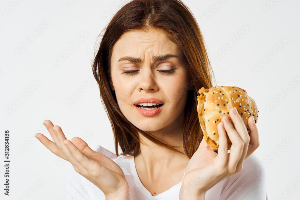 portrait of young woman eating sandwich portrait of young woman eating sandwich