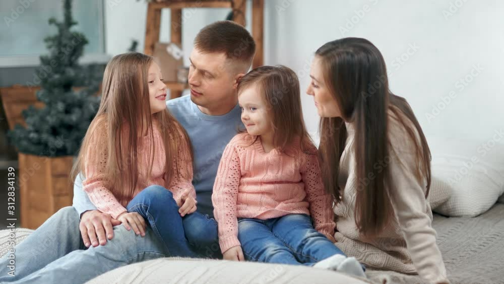 Happy family talking smiling together at Christmas tree background having positive emotion Happy family talking smiling together at Christmas tree background having positive emotion