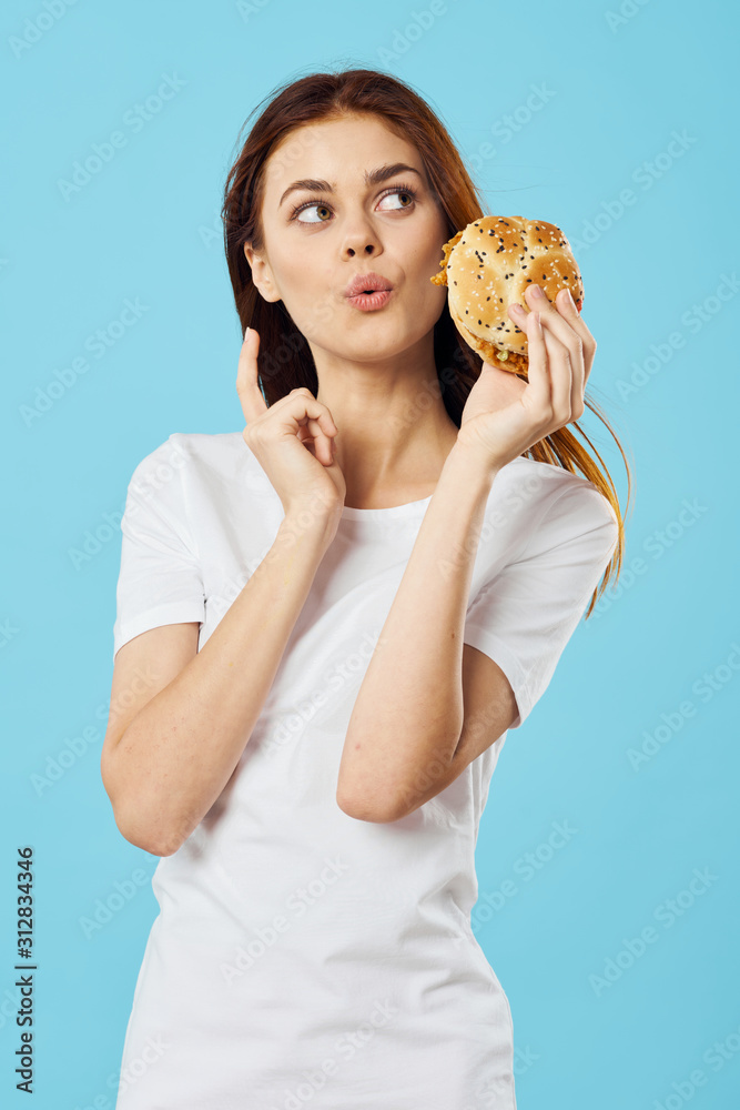 woman with hamburger and french fries woman with hamburger and french fries