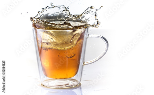 Tea with lemon in a glass thermo cup on a white background.