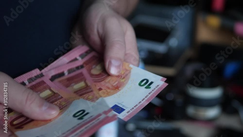 Concept Idea: Bunch of  10 Euro Banknotes in the Male Hand