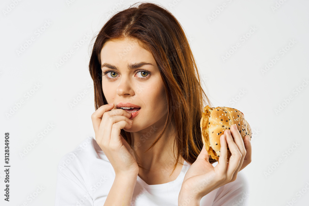 portrait of young woman eating croissant