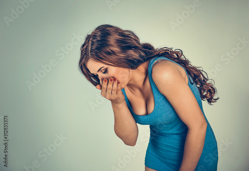 Young woman feeling nauseated about to vomit.