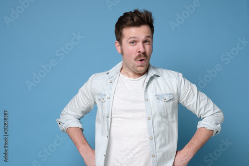 Wow I am suprised. Attractive man with retro mustache standing with open mouth.