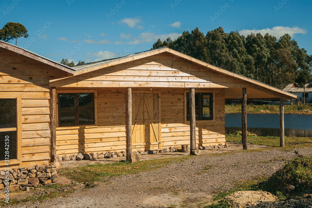Wooden chalet facade with entrance and porch Wooden chalet facade with entrance and porch