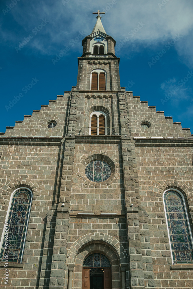 Church facade with steeple and cross in Gramado