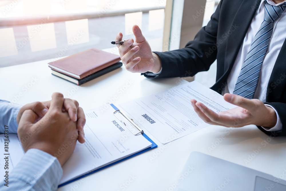 Interview the job and hiring, men candidate at job interview explaining about his profile to business manager in modern office space. Business consulting or employment concept. Interview the job and hiring, men candidate at job interview explaining about his profile to business manager in modern office space. Business consulting or employment concept.
